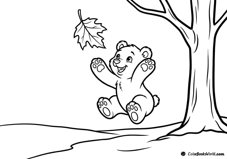 A happy bear cub jumps to catch a large falling autumn leaf in a forest clearing.